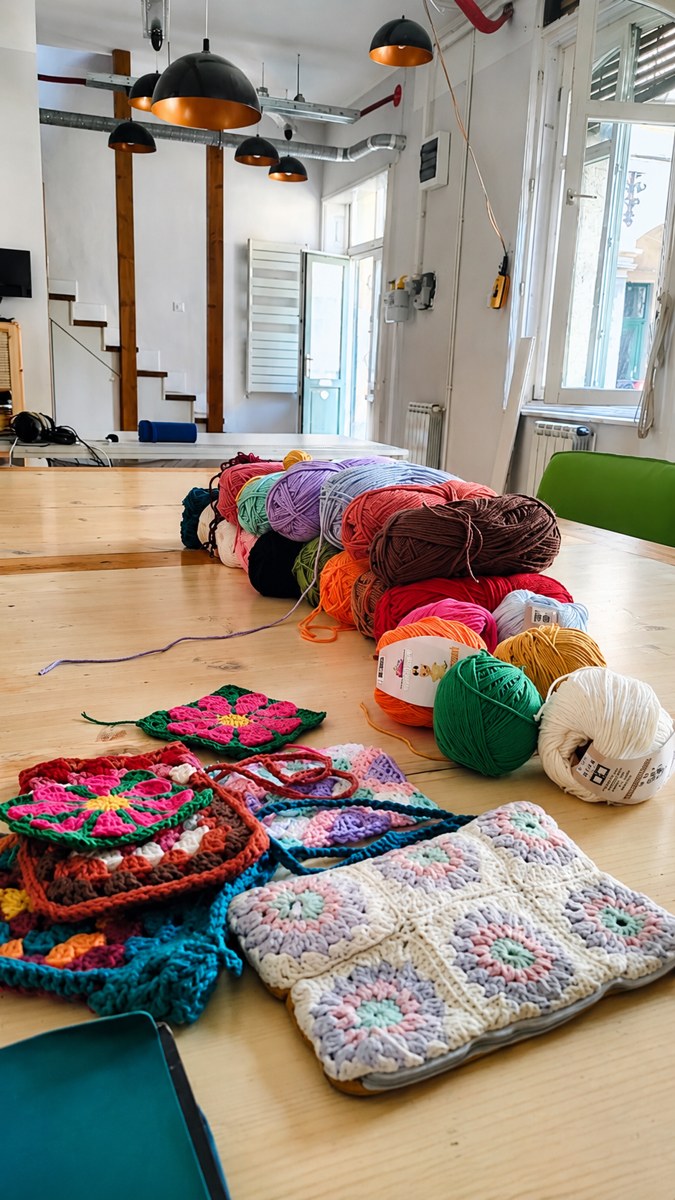 Yarn and crochet squares at the studio